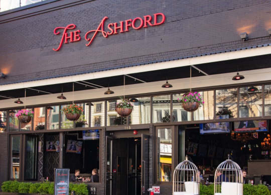 the outside of the ashford restaurant in the city