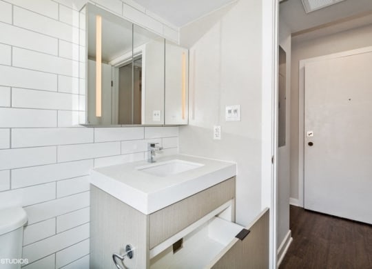 a bathroom with a sink and a mirror at Carver and Slowe Apartments, Washington