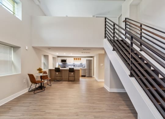 a spacious living room with a staircase leading up to the second floor at Carver and Slowe Apartments, Washington, DC