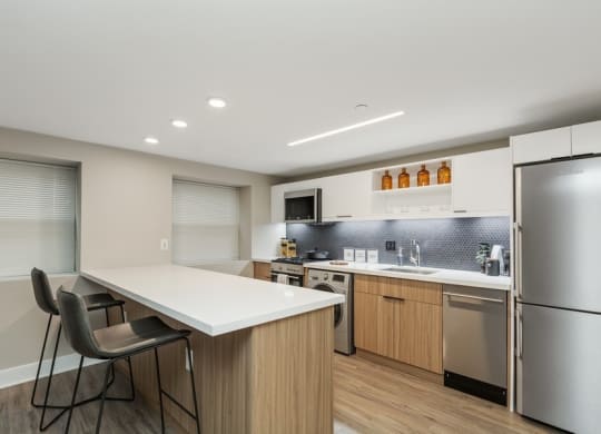 a kitchen with white countertops and wooden cabinets at Carver and Slowe Apartments, Washington, DC