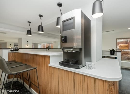 a kitchen with a stove top oven next to a microwave at Carver and Slowe Apartments, Washington