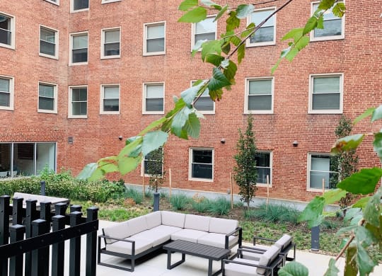 a seating area in front of a brick building at Carver and Slowe Apartments, Washington, Washington, DC 20001