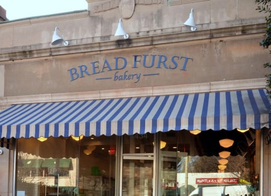 the front of a breadfruit bakery with a blue and white striped canopy  at The Saratoga Apartments, Washington