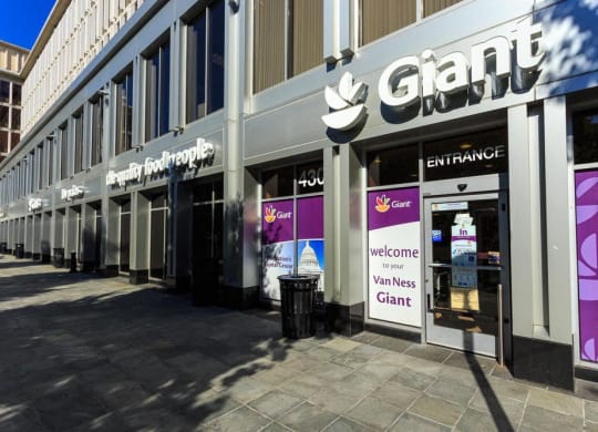 a store front of a building with purple and white signs