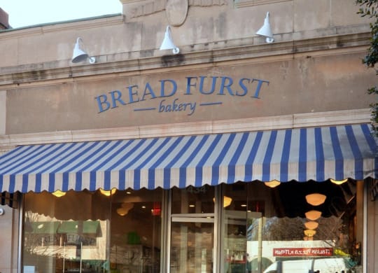 the front of a breadfruit bakery with a blue and white striped canopy