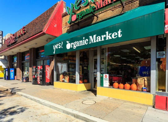 the outside of an organic market on a city street