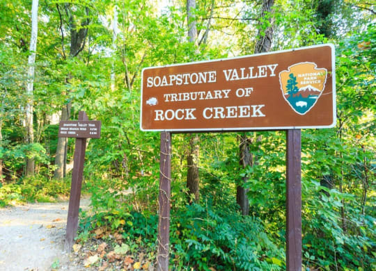 a sign for the sagottic valley tribulation of rock creek in the woods at The Saratoga Apartments, Washington, DC, 20008