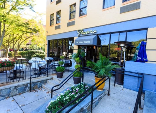 the outside of a restaurant with stairs and a patio at The Saratoga Apartments, Washington, DC, 20008 