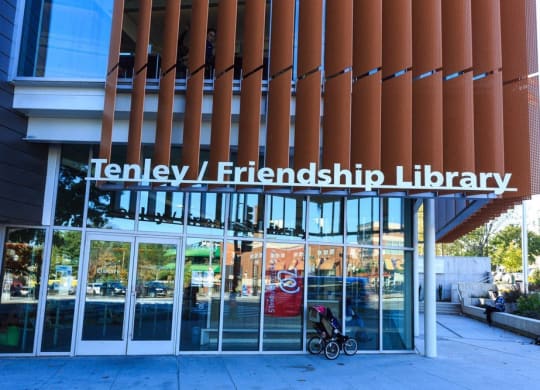 the front of a library building with a wheelchair in front of it