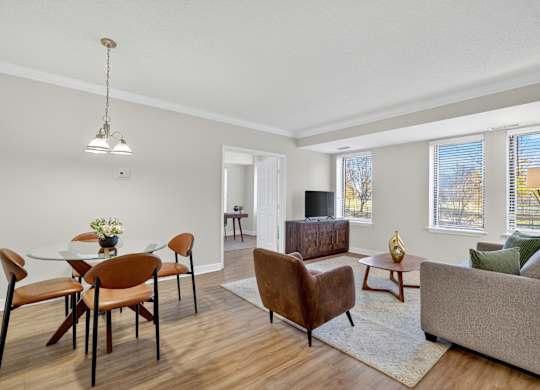 A living room with a dining table and chairs.