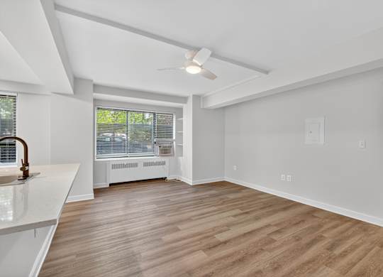 A room with a white ceiling and wooden flooring.