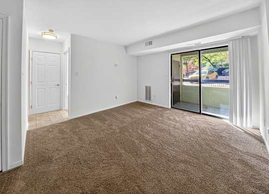 A room with brown carpet and white walls.