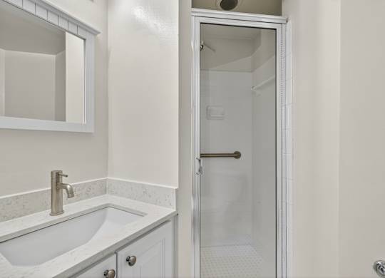 A white sink with a silver faucet in a bathroom.