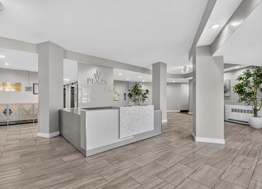 A reception area with a white reception desk and a sign that says