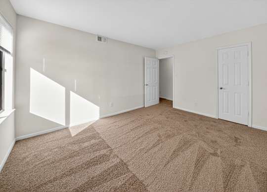 A room with carpeted floor and white walls.