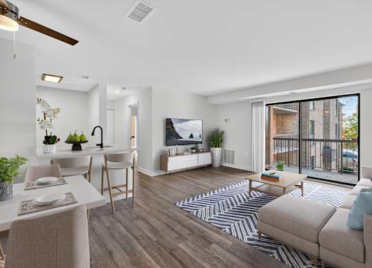 A living room with a couch, a dining table, and a television.