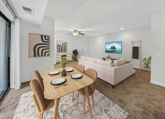 A modern dining room with a wooden table and chairs.