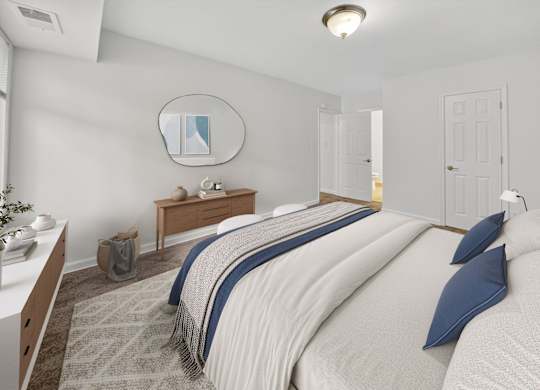 A bedroom with a large bed and a mirror on the wall.