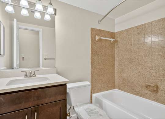 A bathroom with a white sink and a white toilet.