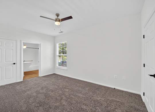 Renovated bedroom with carpet and ceiling fan