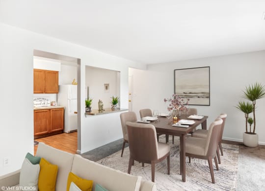 a living room and dining room with a table and chairs