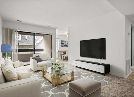 the living room has a large screen tv on the wall