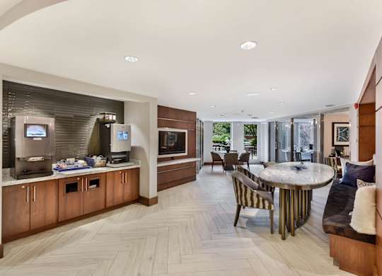 A modern kitchen with a breakfast bar and a dining area.