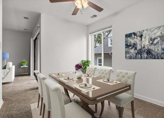 a dining room with a table and chairs and a ceiling fan
