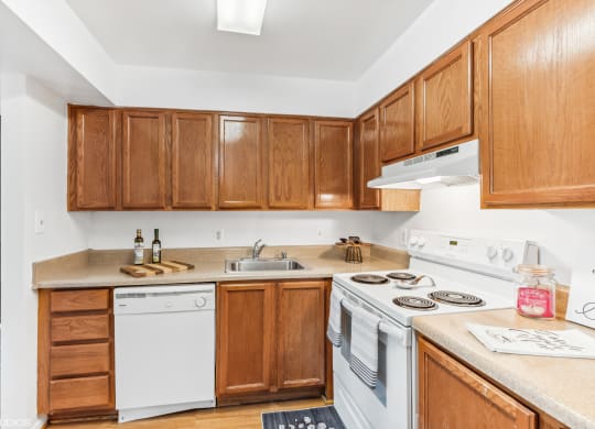 a kitchen with white appliances and wooden cabinets