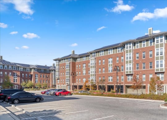 a large brick building with cars parked in a parking lot