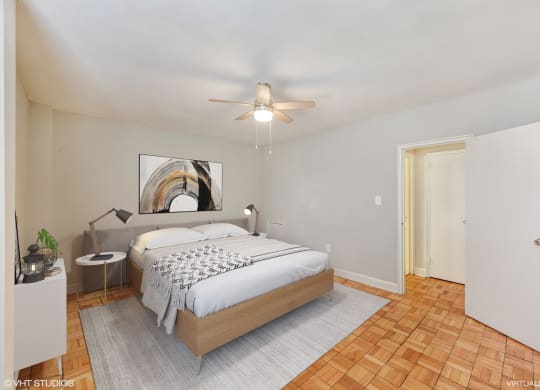 a bedroom with a bed and a ceiling fan at The Chesapeake, Washington