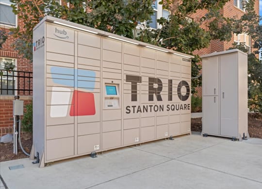 Package locker shed with the trio station square logo on it