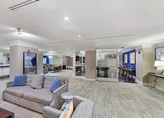 A spacious living room with a grey couch and a television.