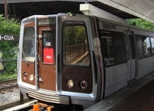 a train that is sitting on the tracks at Brookland Ridge Apartments, Washington DC