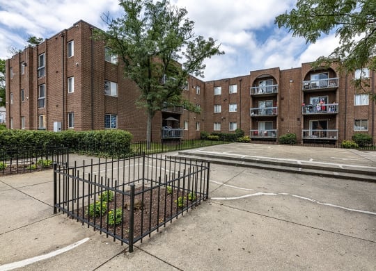 an empty parking lot in front of an apartment building