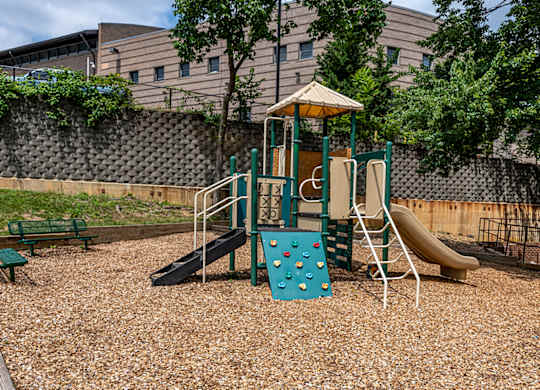 a playground with a swing set and slides