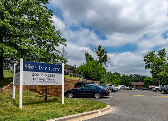 a parking lot with cars parked in front of a city gym sign
