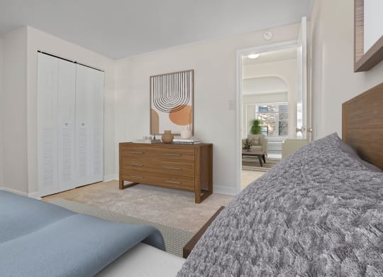 a bedroom with a bed and a dresser with a mirror