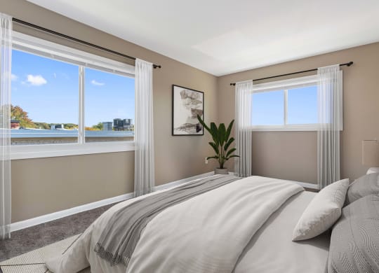 a bedroom with a bed and two windows