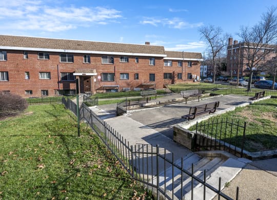 a park in front of a brick building