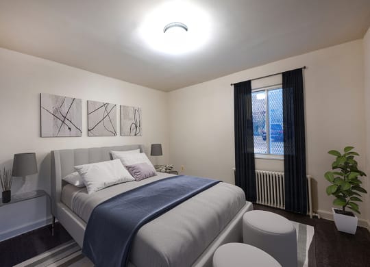 a small bedroom with a bed and a window