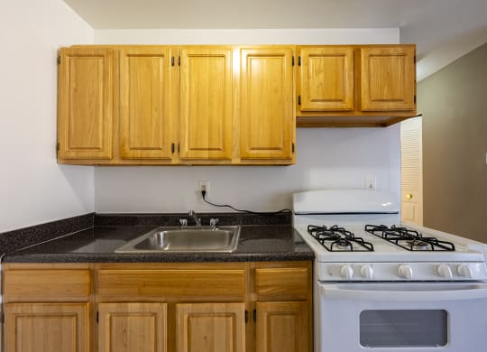 an empty kitchen with a stove and sink