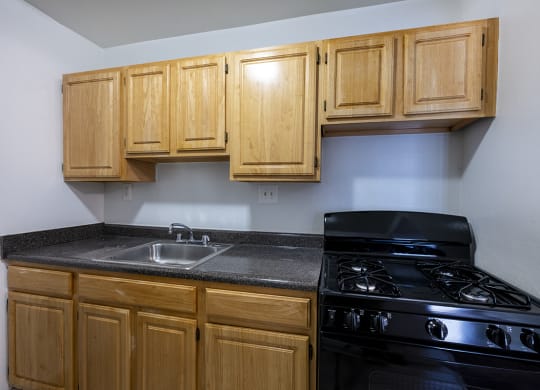 Full Kitchen with Wood Cabinets and Black appliances