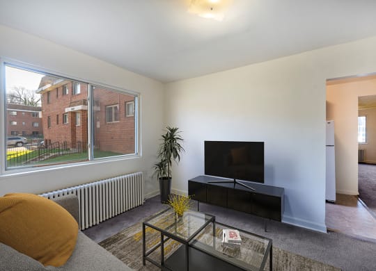 a living room with a large window and a television