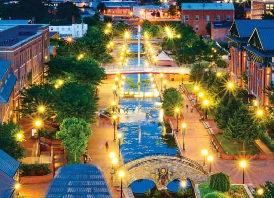 an aerial view of a city street at night at The Residences at the Manor Apartments, Frederick, MD