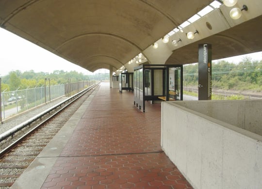 a train station with a train on the tracks
