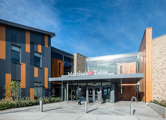 The front of a Martha's Table building with a clear blue sky in the background.
