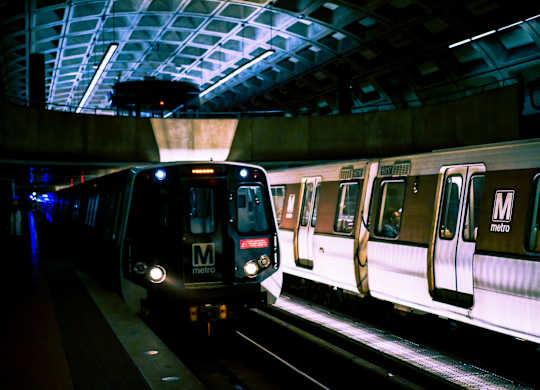 a subway train pulling into a subway station at night