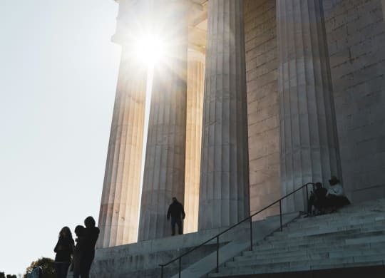 people standing on the steps of the memorial