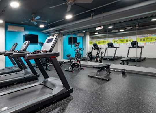 A gym with treadmills and exercise bikes.